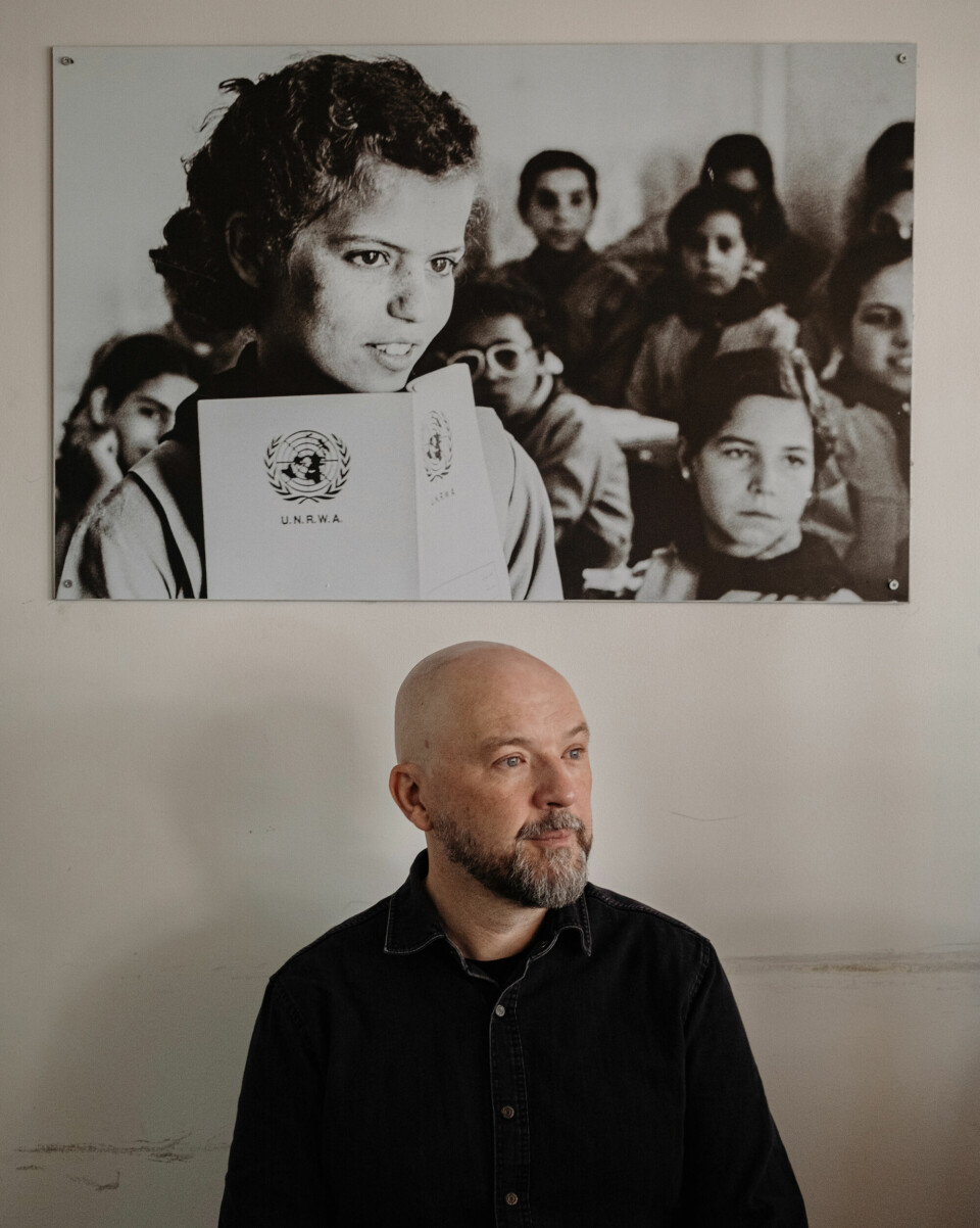 På vakt: Jonathan Fowler, kommunikasjonssjef i FNs hjelpeorganisasjon for palestinske flyktninger i Midtøsten (Unrwa), på sitt kontor i Øst-Jerusalem. Bildet bak han er av palestinske flyktninger i Syria fra 1983.